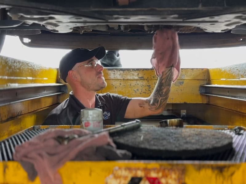 A Don's Quick Lube technician at work in the service bay